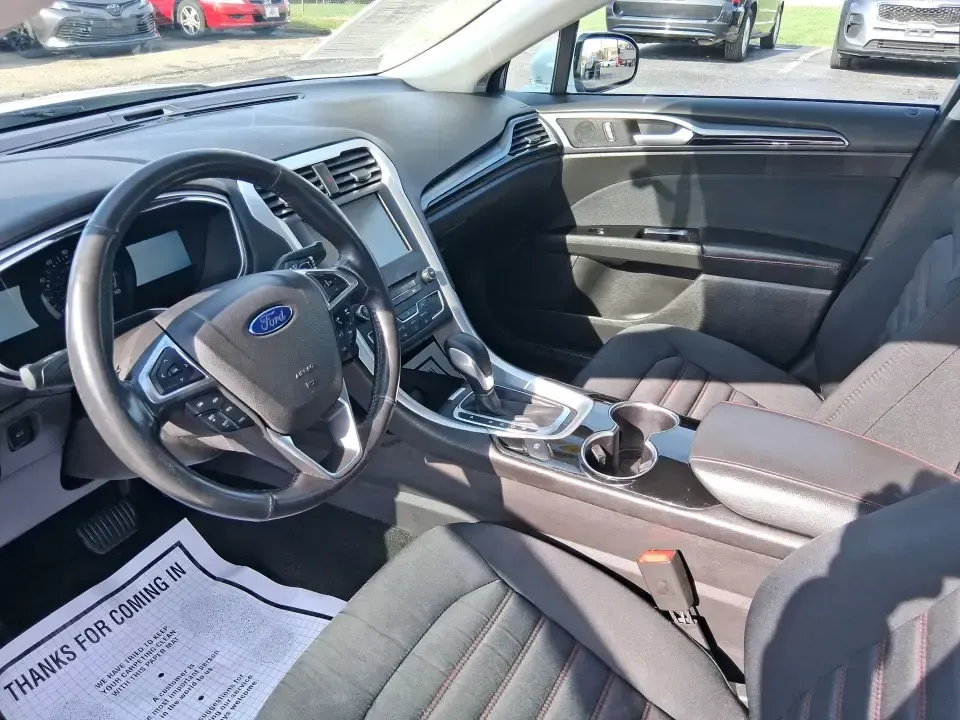 2016 Ford Fusion SE (3FA6P0H91GR) with an 2.0L L4 DOHC 16V engine, 6-Speed Automatic transmission, located at 880 E. National Road, Vandalia, OH, 45377, (937) 908-9800, 39.891918, -84.183594 - Need a dependable commuter that can handle I75 traffic, school drop-offs, and weekend runs to Dayton without draining your budget? This 2016 Ford Fusion SE in Oxford White is the kind of practical, comfortable sedan that fits real life in Vandalia-smooth for daily driving, efficient on regular unlea - Photo#9