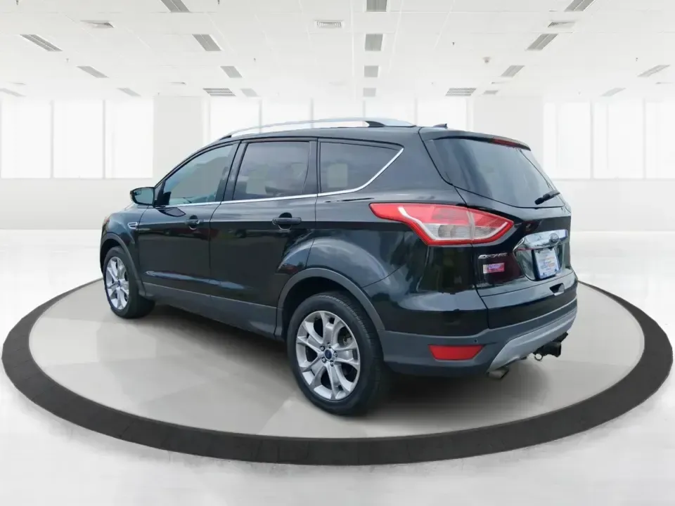2014 Ford Escape Titanium (1FMCU9J99EU) with an 2.0L L4 DOHC 16V engine, 6-Speed Automatic transmission, located at 1099 N County Rd 25A , Troy, OH, 45373, (937) 908-9800, 40.057079, -84.212883 - Need one SUV that can handle an Ohio winter commute, school drop-offs, and a spontaneous weekend road trip to Hocking Hills without feeling like a compromise? This 2014 Ford Escape Titanium 4WD in sleek Tuxedo Black is built for real life in Troy-comfortable for long drives, confident in bad weather - Photo#4
