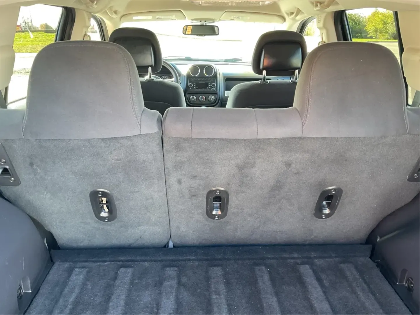 2014 Jeep Compass Sport (1C4NJDBB8ED) with an 2.4L I-4 DOHC engine, located at 1099 N County Rd 25A , Troy, OH, 45373, (937) 908-9800, 40.057079, -84.212883 - Discover the adventure-ready 2014 Jeep Compass, an SUV that's perfect for weekend getaways and daily commutes alike. Whether you're navigating the bustling streets of Troy or heading out on a family road trip to nearby attractions like the Miami County Fair, this rugged vehicle will elevate your dri - Photo#12